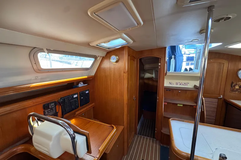 Slide: The Image of Interior of 2004 Hunter 41 Aft Cockpit sailboat with wood finish and navigation equipment. - 56