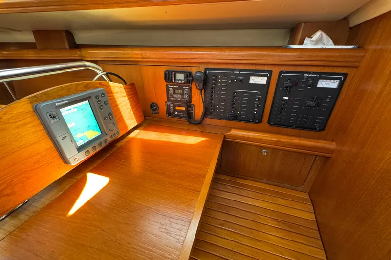 Slide: The Image of Navigation station of 2004 Hunter 41 Aft Cockpit yacht with control panels and GPS. - 57