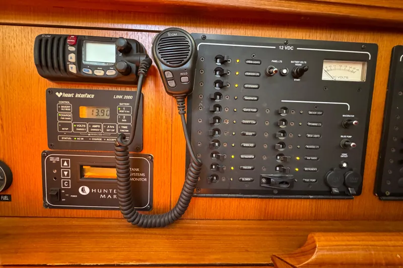 Slide: The Image of Control panel of a 2004 Hunter 41 Aft Cockpit sailboat with communication and monitoring systems. - 58
