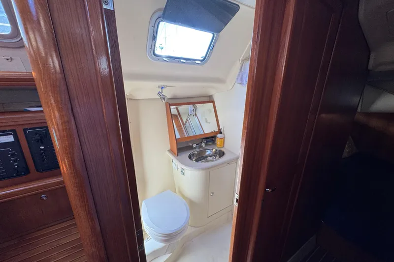 Slide: The Image of Interior of 2004 Hunter 41 Aft Cockpit yacht bathroom with sink and toilet. - 60