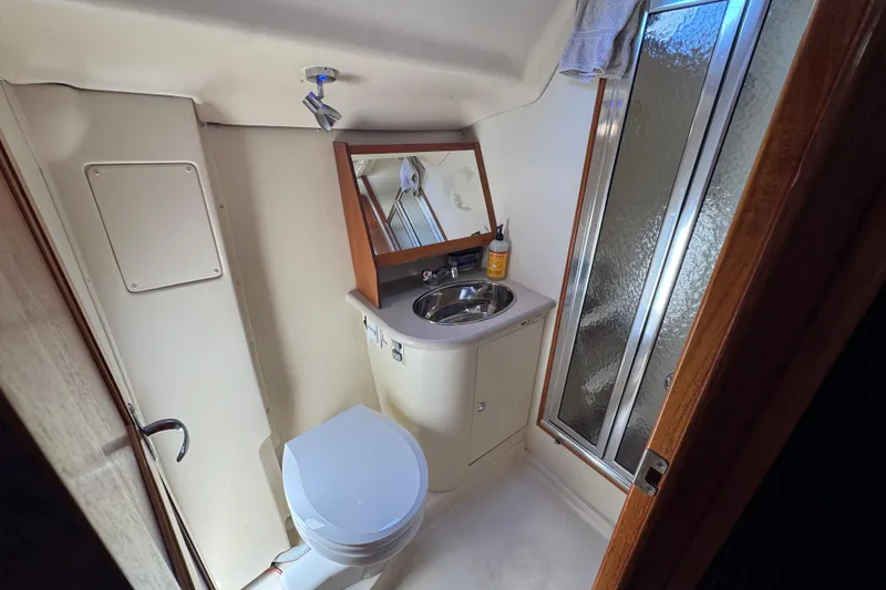 Slide: The Image of Compact bathroom in 2004 Hunter 41 Aft Cockpit yacht with sink, toilet, and shower. - 61