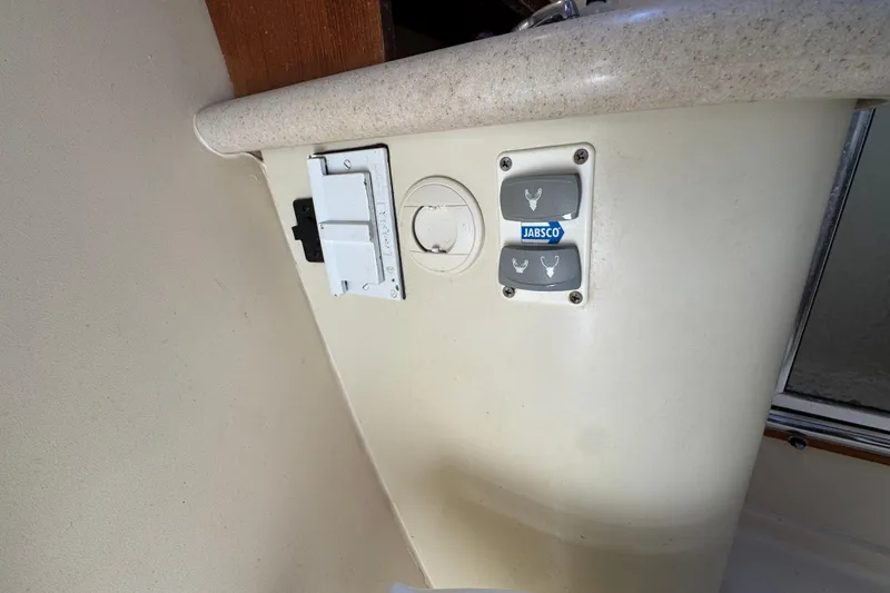 Slide: The Image of Control panel on 2004 Hunter 41 Aft Cockpit yacht with Jabsco switches. - 62