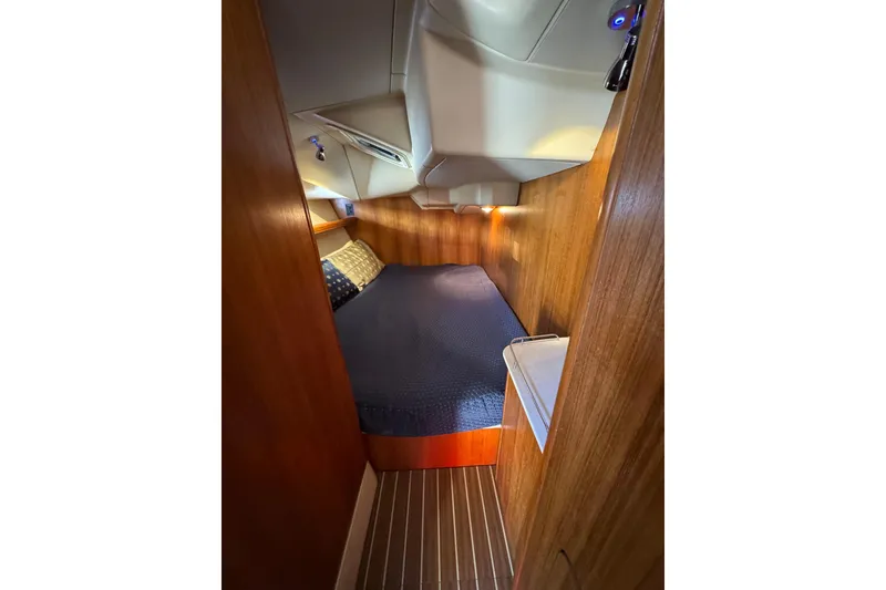 Slide: The Image of Cozy cabin interior of 2004 Hunter 41 Aft Cockpit sailboat with wooden paneling. - 65