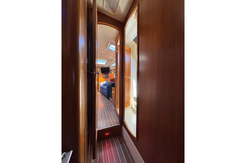 Slide: The Image of Interior view of 2004 Hunter 41 Aft Cockpit yacht, featuring wooden paneling and cozy cabin space. - 68