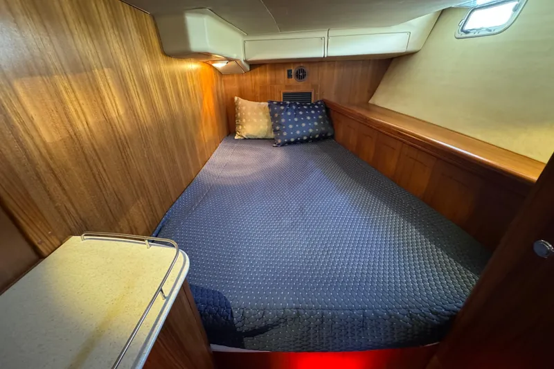 Slide: The Image of Cozy cabin interior of 2004 Hunter 41 Aft Cockpit sailboat with wood paneling and bedding. - 71