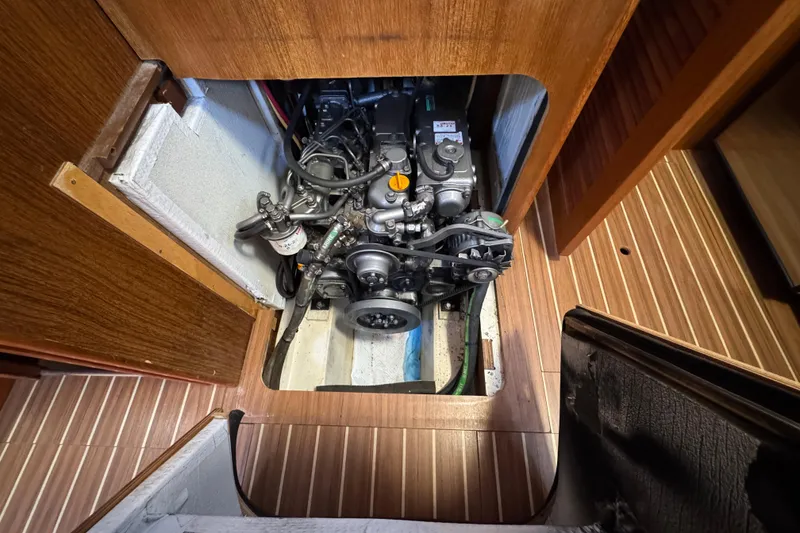 Slide: The Image of Engine compartment of 2004 Hunter 41 Aft Cockpit sailboat, showcasing mechanical components. - 73