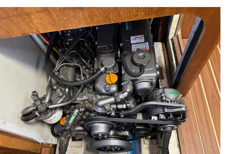 Slide: The Image of Engine compartment of a 2004 Hunter 41 Aft Cockpit sailboat, showcasing mechanical components. - 74