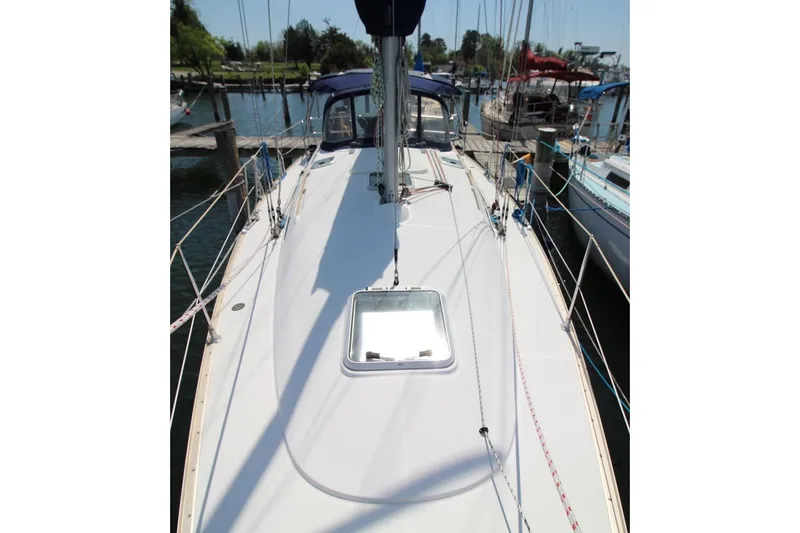 Slide: The Image of 2004 Jeanneau Sun Odyssey 35 sailboat docked at a marina, viewed from the deck. - 11