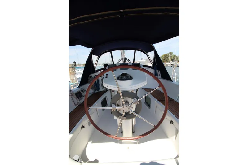 Slide: The Image of 2004 Jeanneau Sun Odyssey 35 sailboat cockpit with steering wheel and navigation instruments. - 14