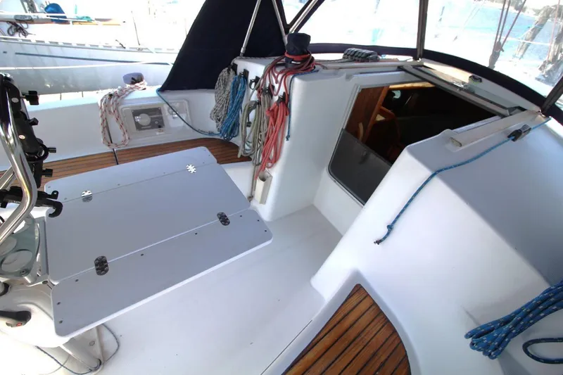 Slide: The Image of Cockpit of 2004 Jeanneau Sun Odyssey 35 sailboat with ropes and seating area. - 16
