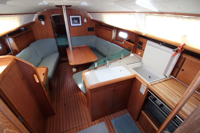 Slide: The Image of Interior of 2004 Jeanneau Sun Odyssey 35 sailboat with cozy seating and compact kitchen. - 17