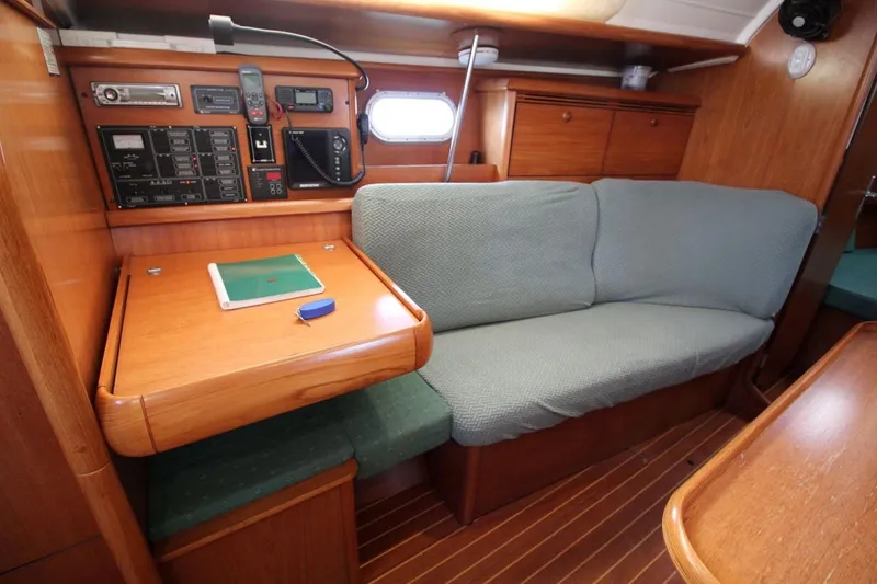 Slide: The Image of 2004 Jeanneau Sun Odyssey 35 interior with navigation station and cozy seating area. - 20