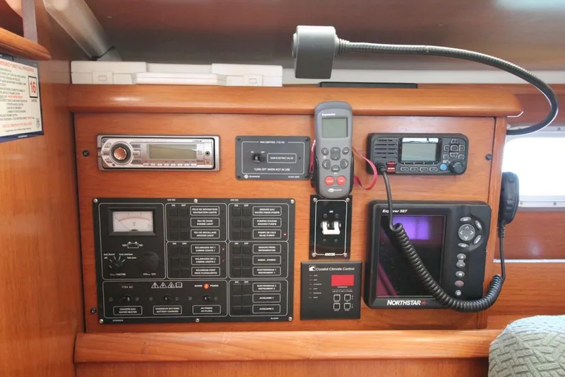 Slide: The Image of Control panel of a 2004 Jeanneau Sun Odyssey 35 sailboat with navigation and communication equipment. - 21