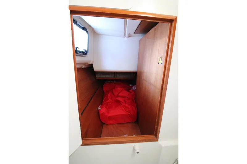 Slide: The Image of Interior cabin view of 2004 Jeanneau Sun Odyssey 35 sailboat with red bedding. - 27