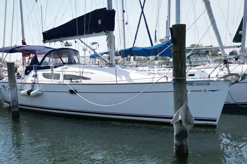 Slide: The Image of 2004 Jeanneau Sun Odyssey 35 sailboat docked in a marina, side view. - 3