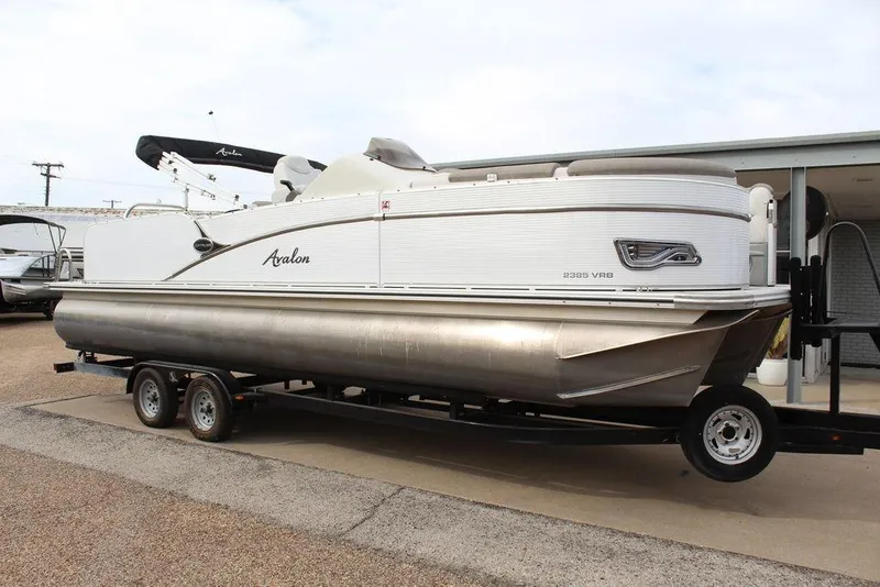 The Image of 2020 Avalon Catalina Versatile Rear Bench 23' pontoon boat on trailer, side view. - 2