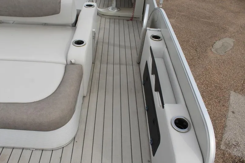 Slide: The Image of 2020 Avalon Catalina Versatile Rear Bench 23' interior with seating and cup holders. - 5