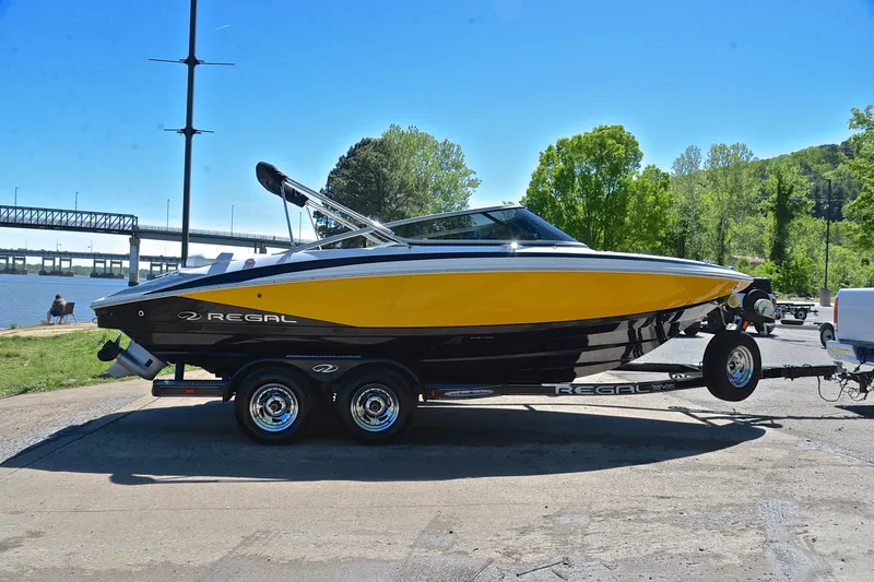 Slide: The Image of 2014 Regal 2100 boat on trailer by riverside, sunny day. - 15