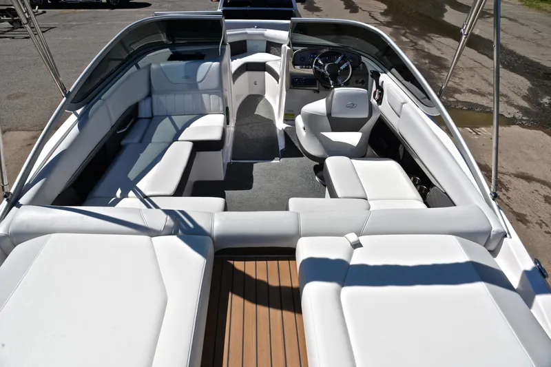 Slide: The Image of 2014 Regal 2100 boat interior with white seating and sleek design. - 18