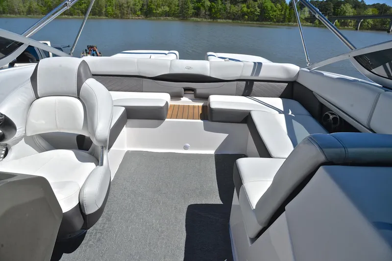 Slide: The Image of Luxurious interior of a 2014 Regal 2100 boat with plush seating and scenic lake view. - 22