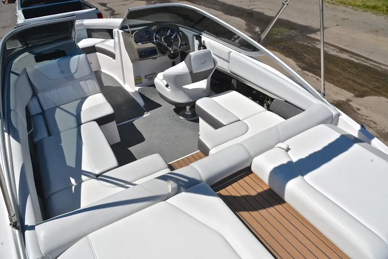 Slide: The Image of 2014 Regal 2100 boat interior with white seating and modern dashboard. - 23