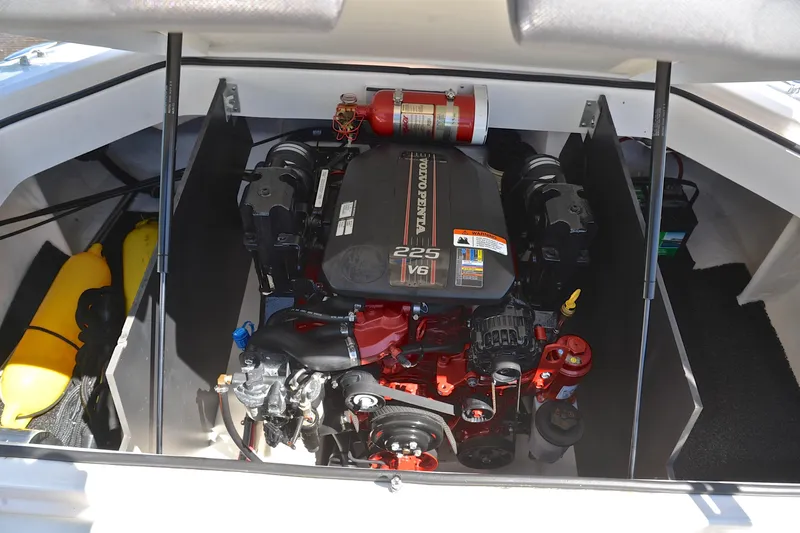 Slide: The Image of Engine compartment of a 2014 Regal 2100 boat featuring a Volvo Penta 225 V6 engine. - 27