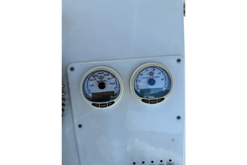 Slide: The Image of Dashboard of a 2008 Triton 225 CC boat showing speedometer and tachometer gauges. - 12