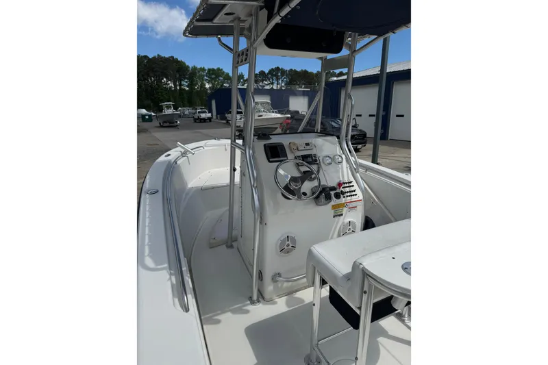 Slide: The Image of 2008 Triton 225 CC boat interior with steering console and seating. - 5