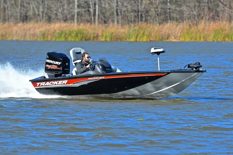 The Image of 2018 Bass Tracker Pro 19 boat speeding on a lake with a Mercury engine. - 1