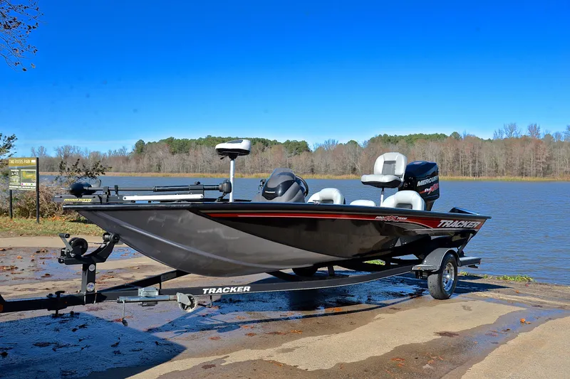 Slide: The Image of 2018 Bass Tracker Pro 19 boat on trailer by a lake. - 10