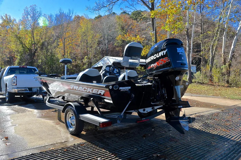 Slide: The Image of 2018 Bass Tracker Pro 19 boat on trailer, featuring Mercury 150 Pro XS engine, in scenic autumn setting. - 12