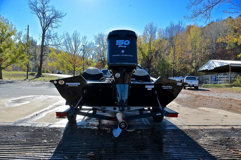 Slide: The Image of 2018 Bass Tracker Pro 19 boat with 150 Pro motor on trailer, autumn backdrop. - 13