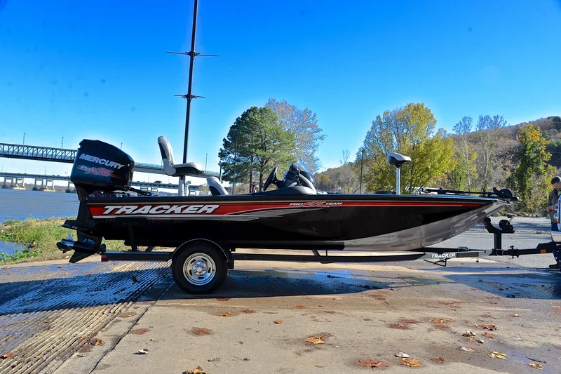 Slide: The Image of 2018 Bass Tracker Pro 19 boat on trailer by riverside, clear blue sky. - 15