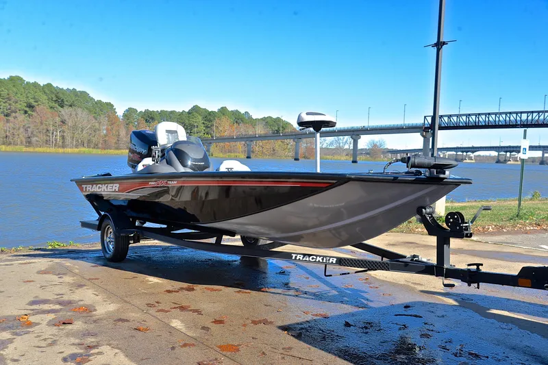 Slide: The Image of 2018 Bass Tracker Pro 19 boat on trailer by a scenic river. - 16