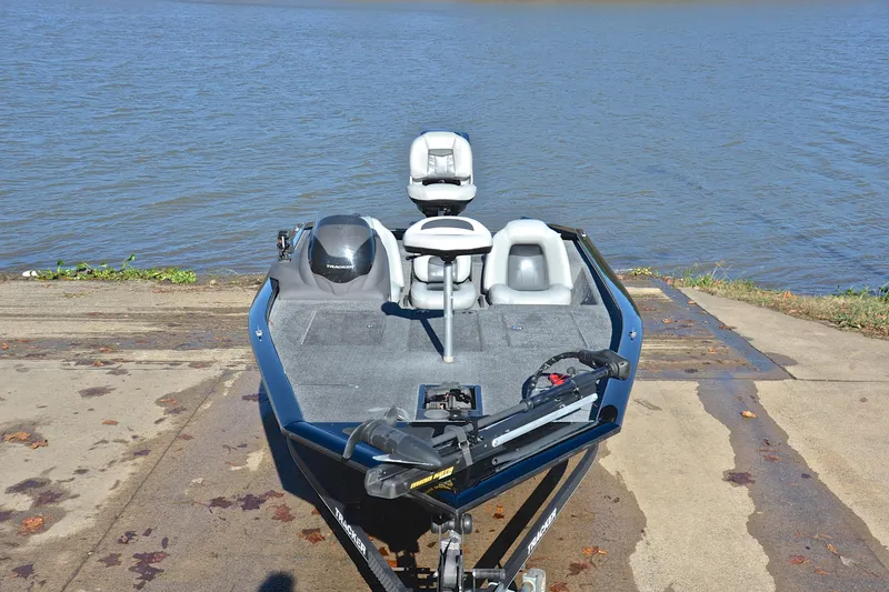 Slide: The Image of 2018 Bass Tracker Pro 19 boat at a lakeside launch ramp. - 17