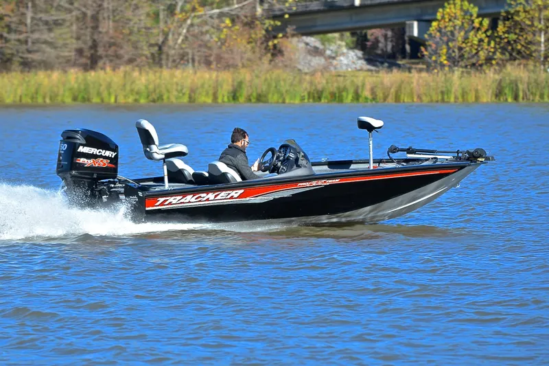 Slide: The Image of 2018 Bass Tracker Pro 19 boat speeding on a lake with a Mercury engine. - 3