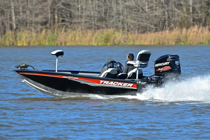 Slide: The Image of 2018 Bass Tracker Pro 19 boat speeding on a lake with Mercury engine. - 4