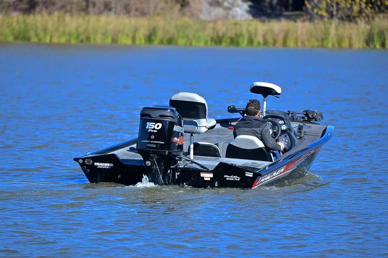 Slide: The Image of 2018 Bass Tracker Pro 19 boat on a lake, featuring a Mercury 150 Pro motor. - 8