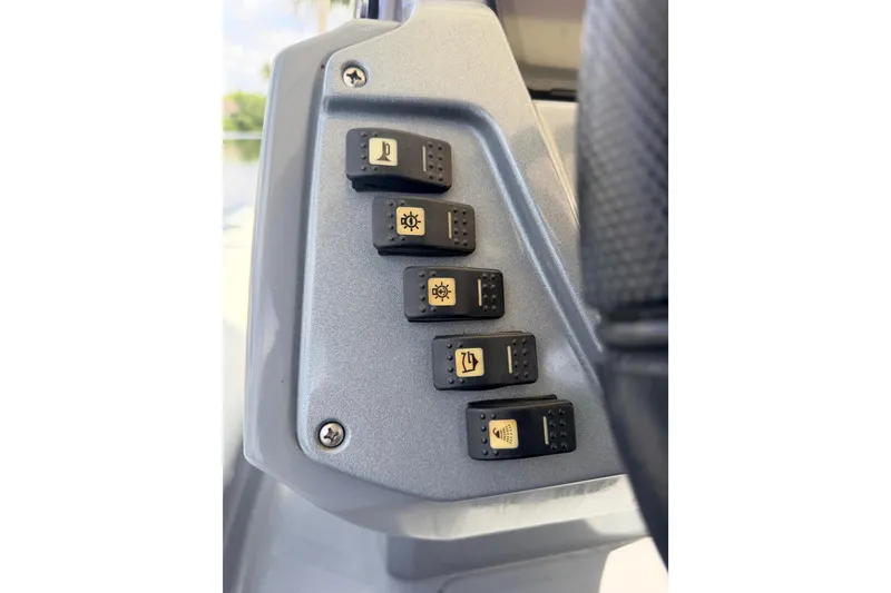 Slide: The Image of Control panel of 2020 Grand Inflatables G580 boat with labeled switches. - 26