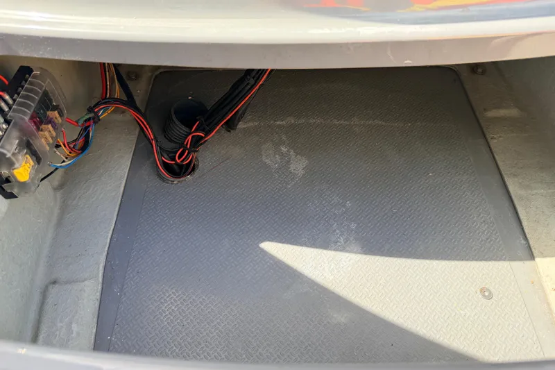 Slide: The Image of Storage compartment of a 2020 Grand Inflatables G580 boat, featuring wiring and fuse box. - 29