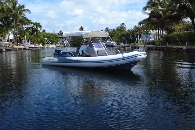 Slide: The Image of 2020 Grand Inflatables G580 boat cruising on a calm, tropical waterway. - 3