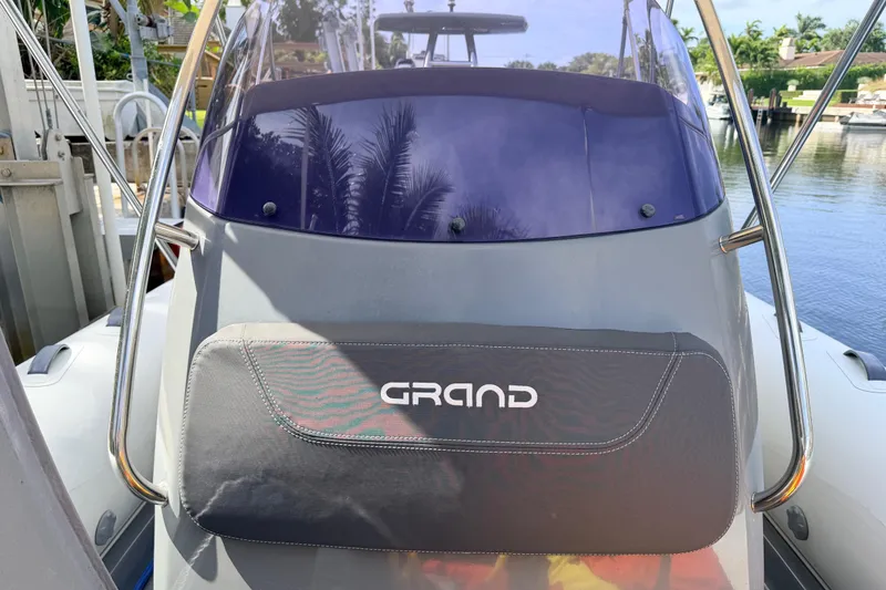 Slide: The Image of 2020 Grand Inflatables G580 boat with sleek design and modern features, docked by the water. - 31