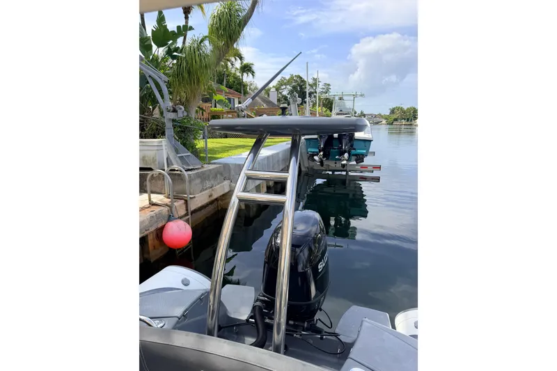 Slide: The Image of 2020 Grand Inflatables G580 boat docked by a canal with lush greenery. - 32