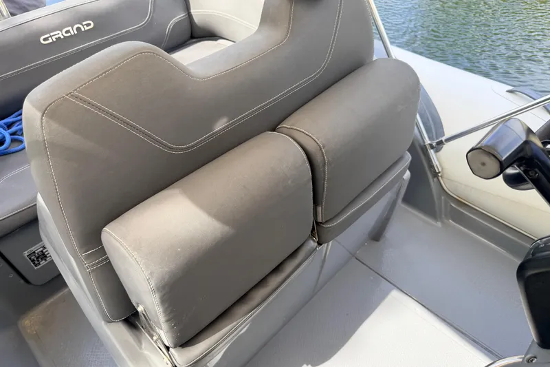 Slide: The Image of 2020 Grand Inflatables G580 boat seat with gray upholstery, near water. - 36