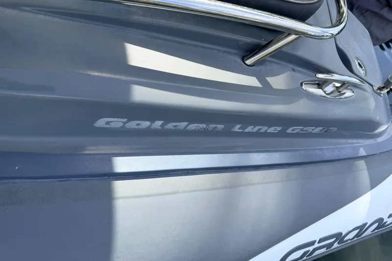 Slide: The Image of 2020 Grand Inflatables G580 boat, close-up of "Golden Line G580" branding. - 37