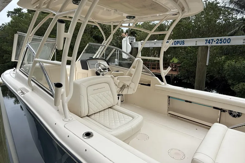 Slide: The Image of 2021 Grady-White Freedom 255 boat interior with seating and steering wheel. - 2