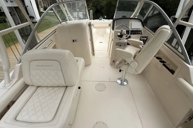 Slide: The Image of 2021 Grady-White Freedom 255 boat interior with luxurious seating and modern helm. - 4