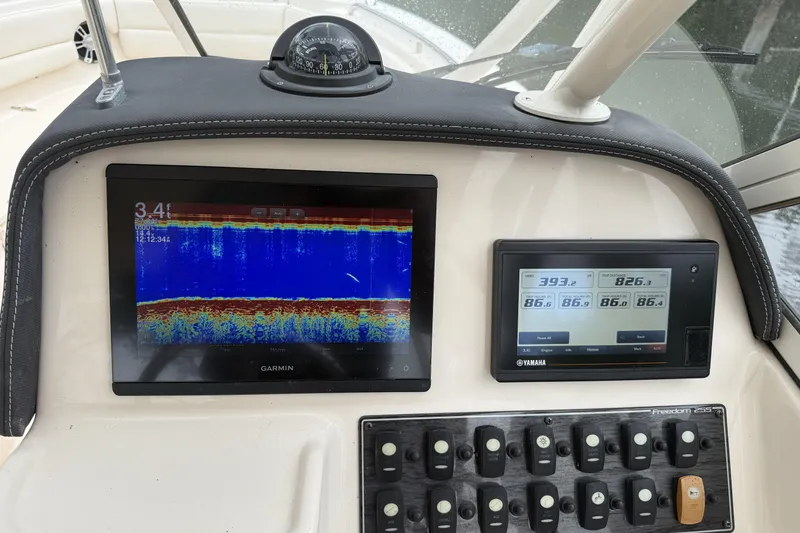 Slide: The Image of Dashboard of 2021 Grady-White Freedom 255 with Garmin and Yamaha displays. - 9