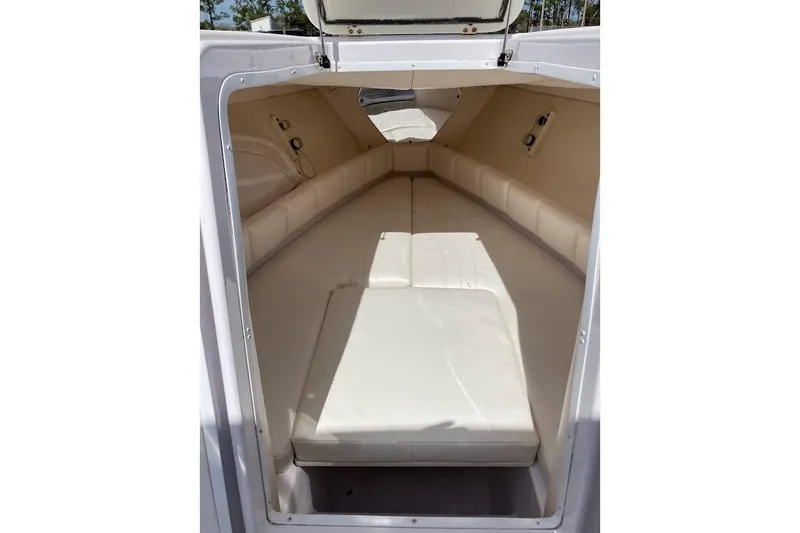 Slide: The Image of Interior cabin of a 2005 Donzi 35 ZF Daytona boat, featuring beige seating. - 19