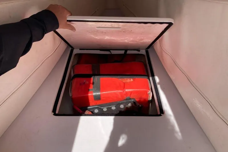 Slide: The Image of Storage compartment on a 2005 Donzi 35 ZF Daytona boat, containing life jackets. - 22